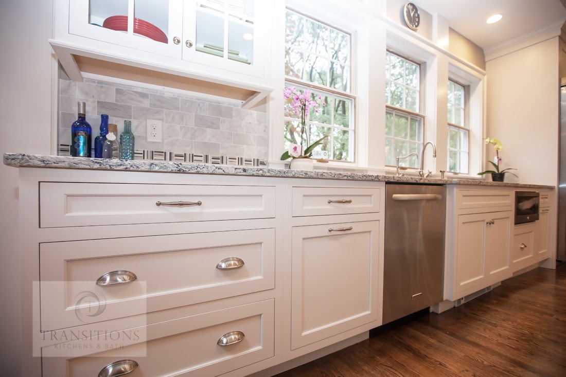 White kitchen design with stainless steel appliances