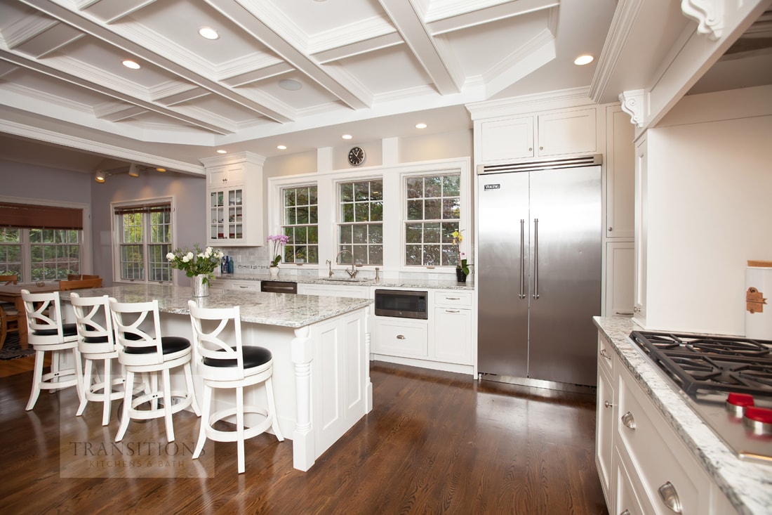 White kitchen design with large island