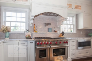Traditional kitchen design with wood mantel hood