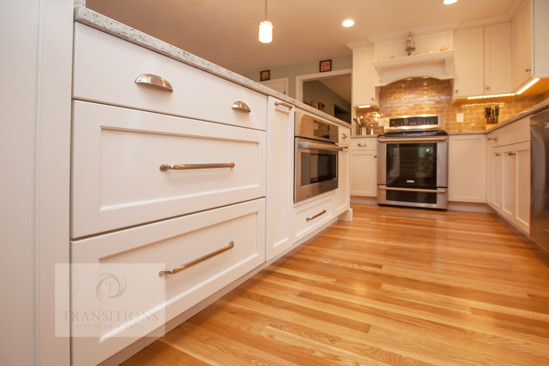 white kitchen design with wood floors