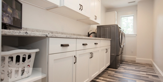 laundry room design with white cabinets