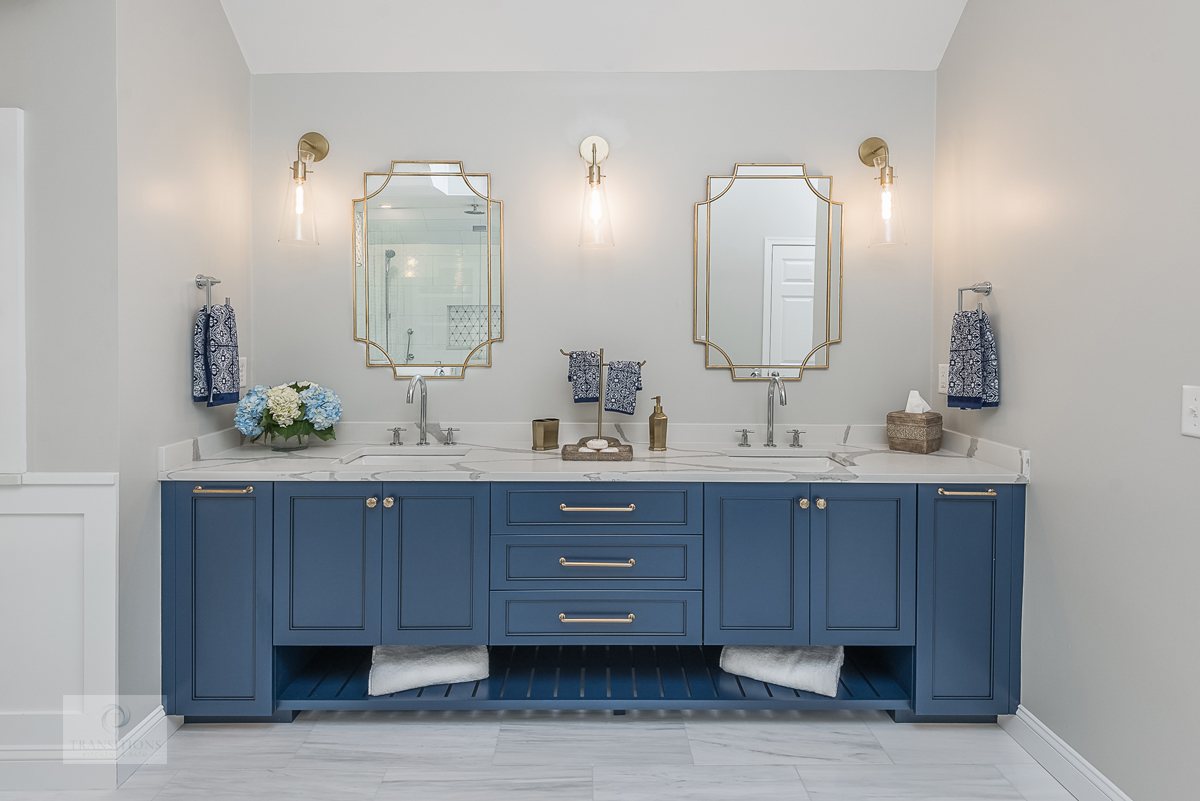 master bath design with blue vanity and gold accessories