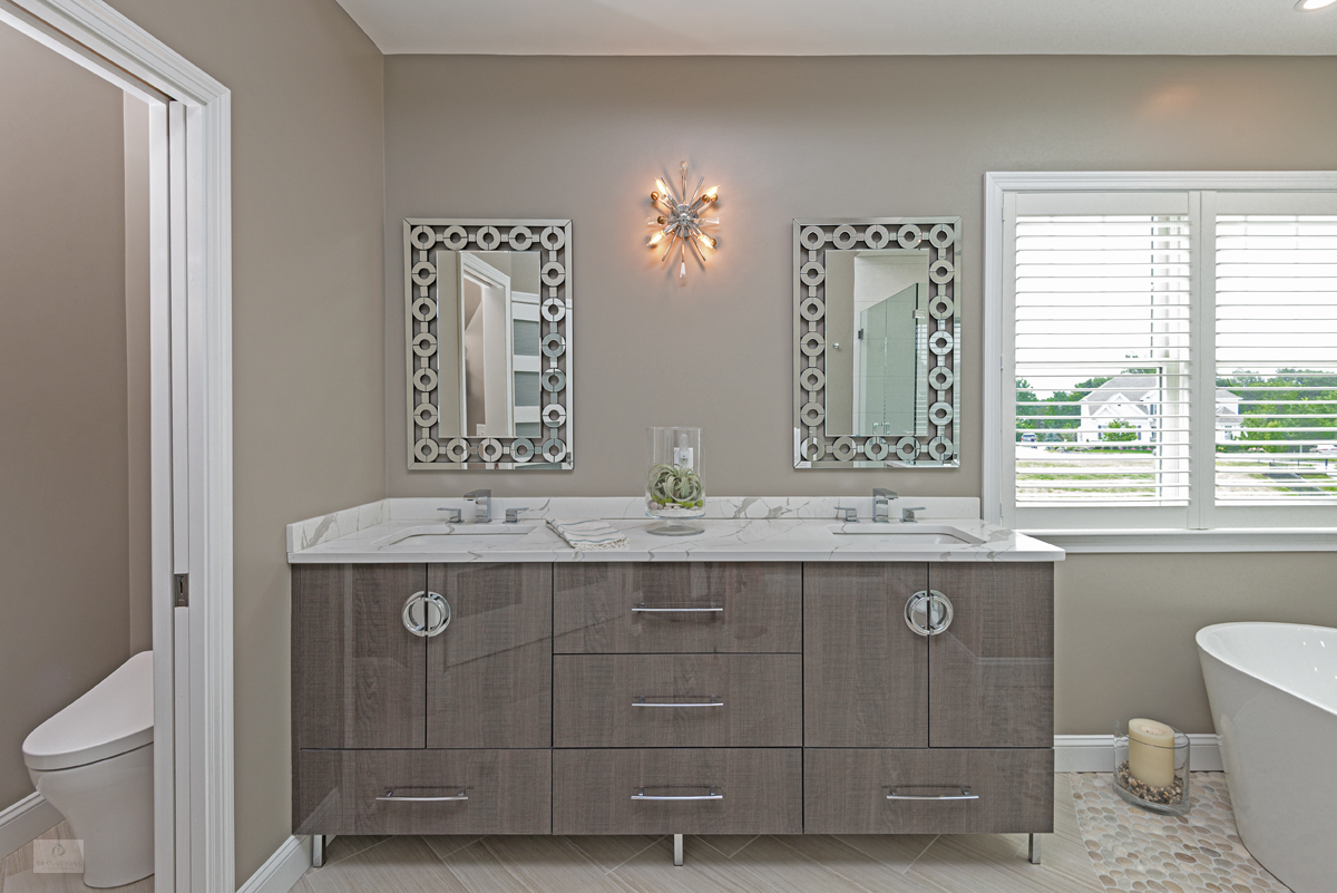 master bath design with vanity, freestanding tub, and toilet compartment