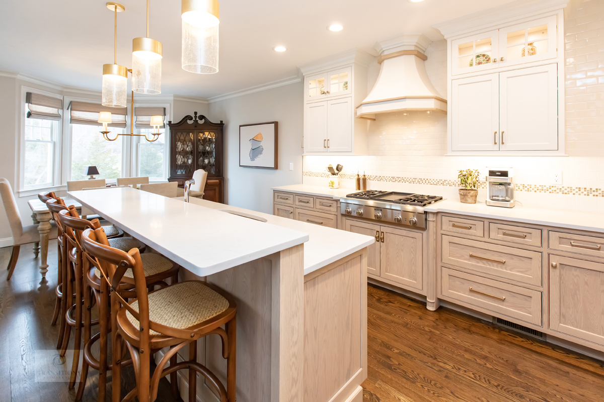 kitchen island with glass and brass pendant lights